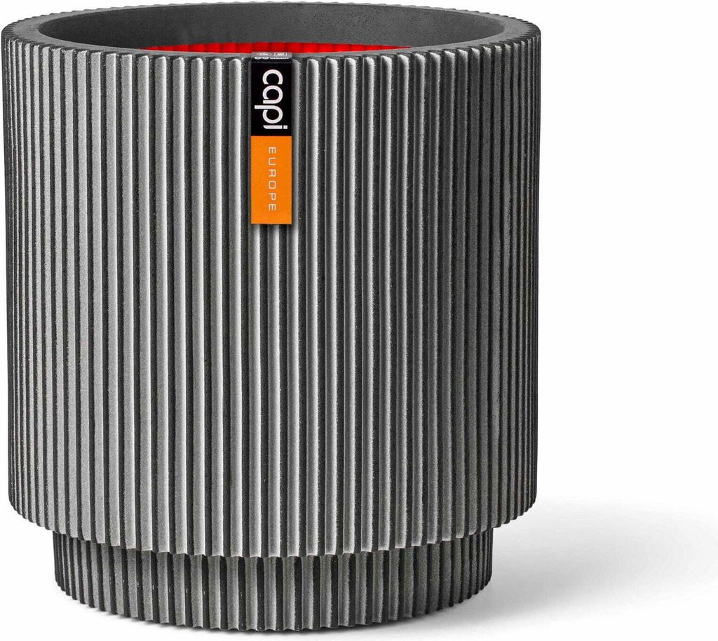 A cylindrical planter with a ribbed texture and a label attached.