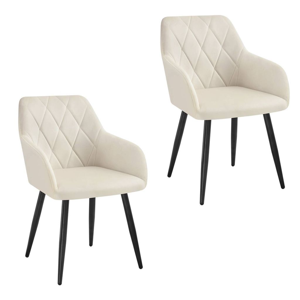 Two cream-colored dining chairs with diamond-stitched upholstery and black metal legs are shown against a white background.