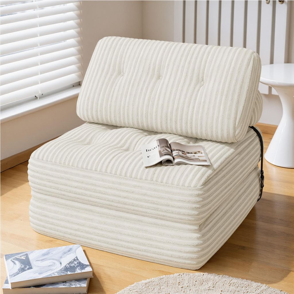 A beige corduroy sofa bed is shown in a room with blinds and a white side table.