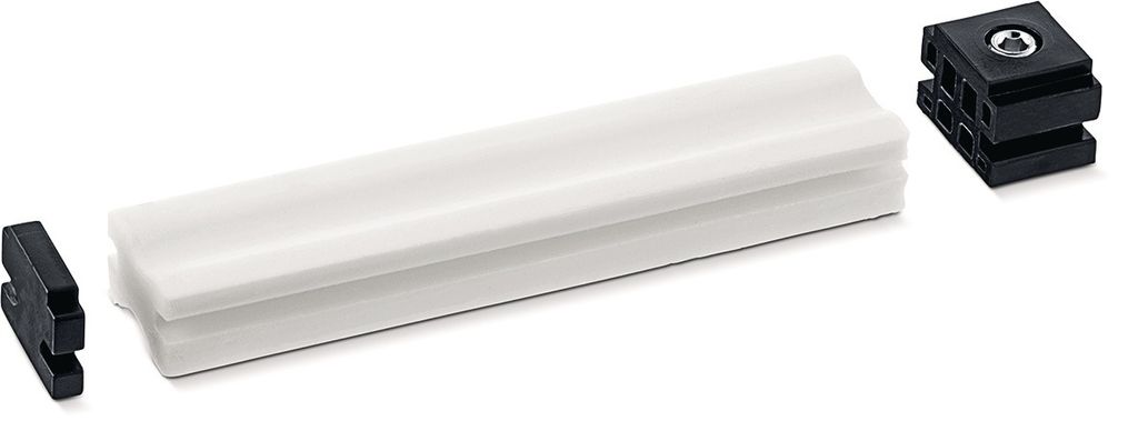 A white damping element and two black connectors are arranged on a white background.