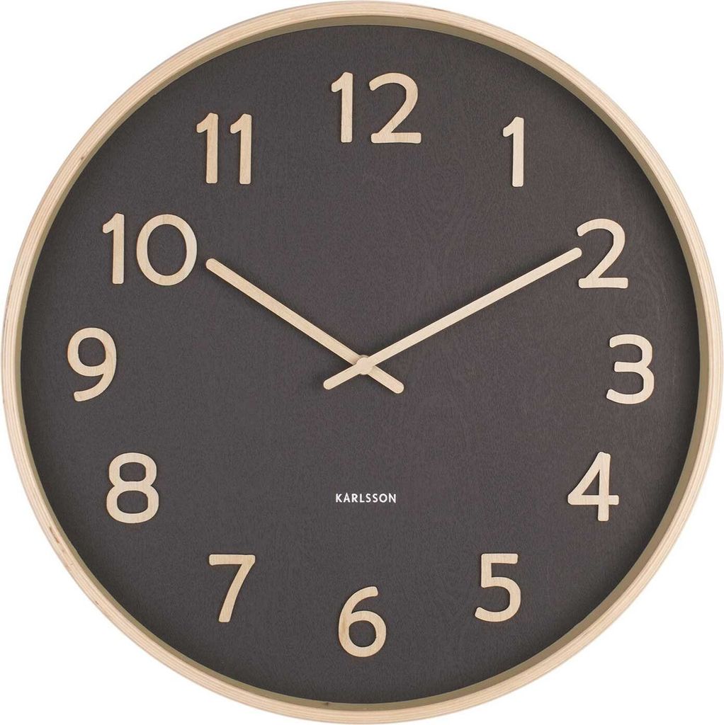 A close-up view of a wall clock with a dark gray face and a light wood frame.