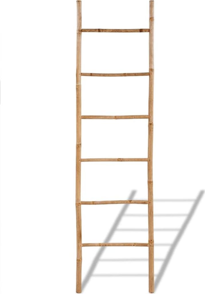 A bamboo ladder leaning against a white background.