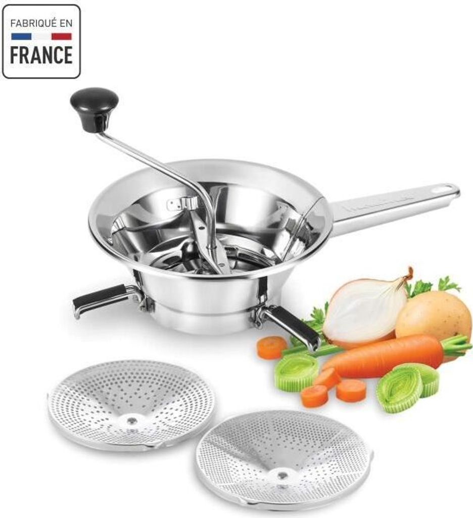 A stainless steel food mill with two interchangeable discs, along with some vegetables like carrots, leeks, and onions, are displayed on a white background.