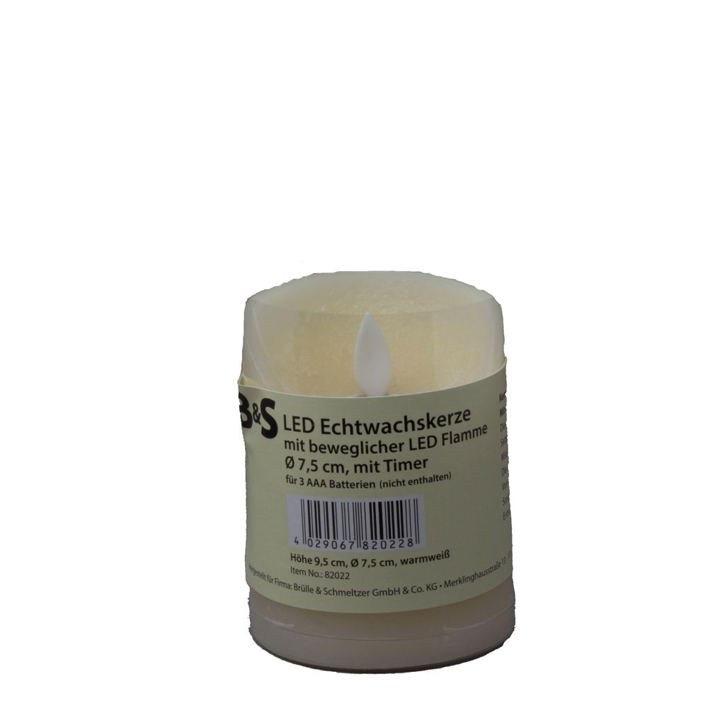 A close-up of a cream-colored LED candle with a label wrapped around it.