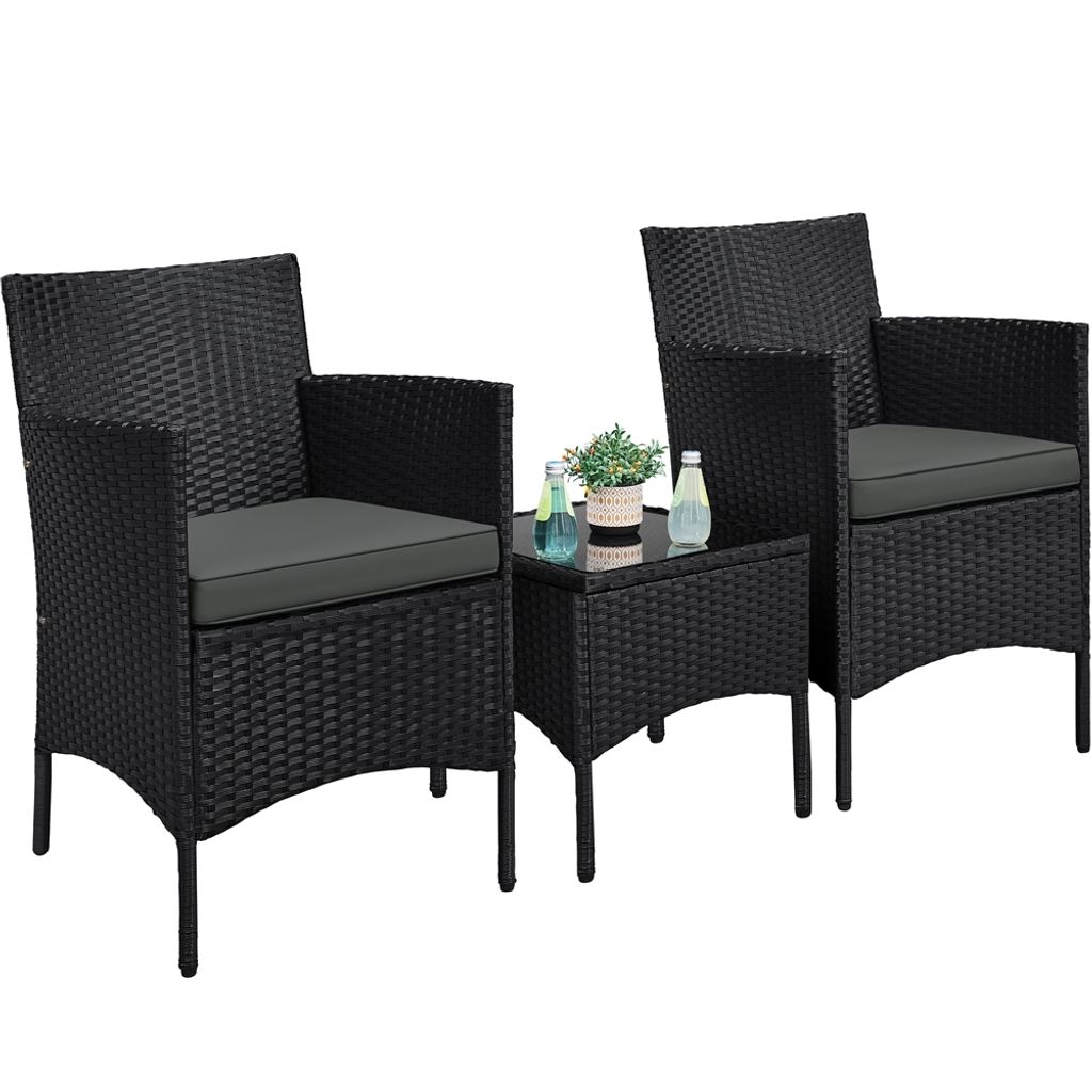 A black rattan furniture set with two chairs and a small table on a white background.