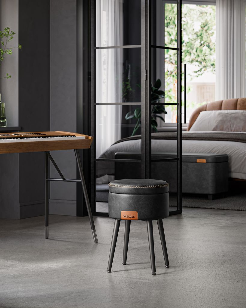 A stool with storage in a modern room with a bed and a keyboard stand.