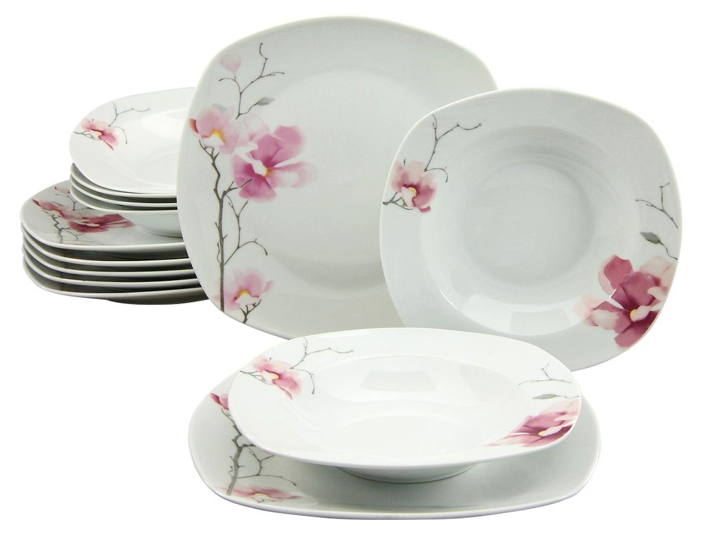 A set of white porcelain dinnerware with pink floral accents.