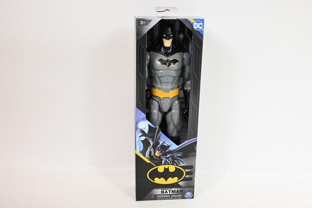 A Batman action figure is displayed in its retail packaging against a white background.