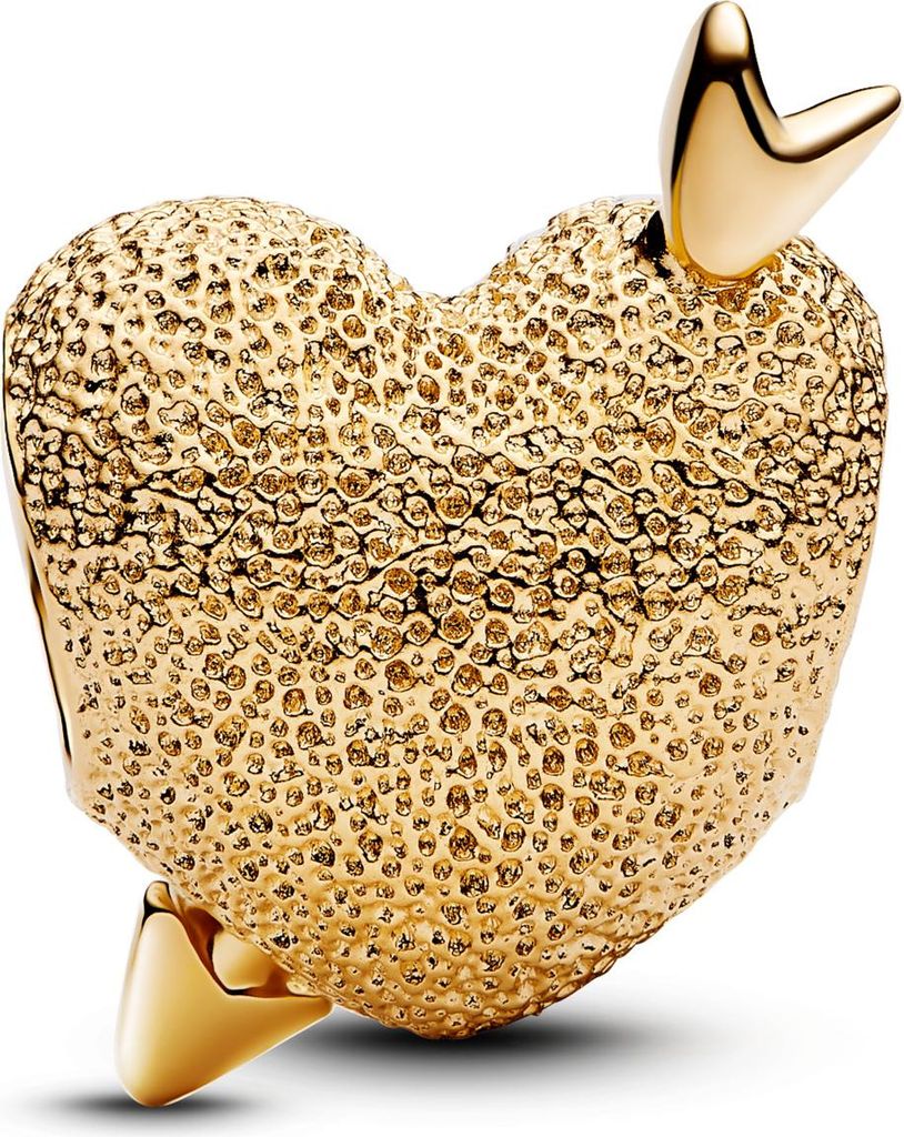A close-up studio shot of a gold heart-shaped charm pierced by an arrow.