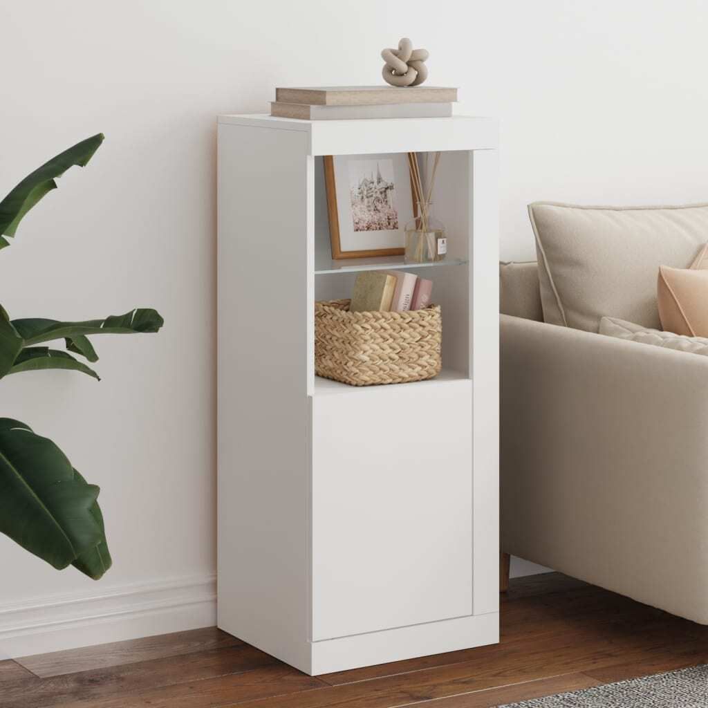 A white storage cabinet with shelves and a basket is shown next to a sofa and a plant.
