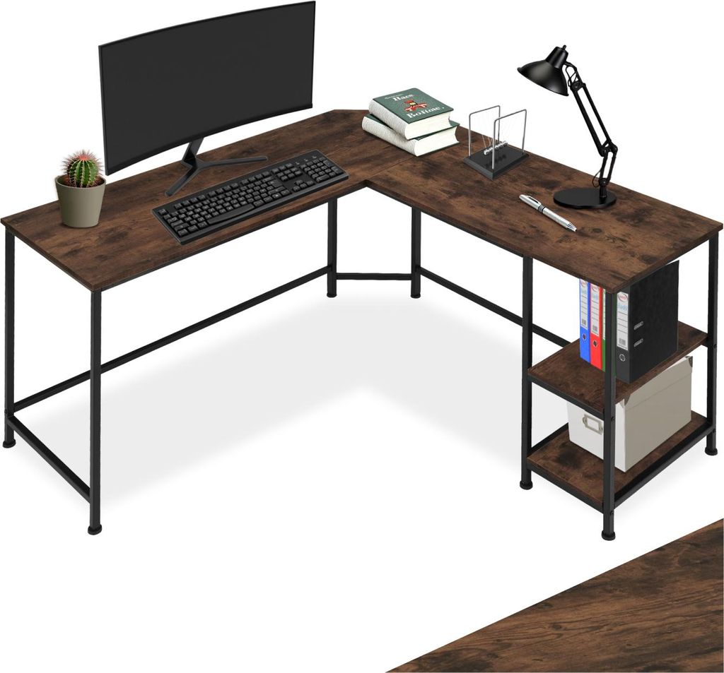 A corner desk with a computer, keyboard, lamp, books, and a plant.