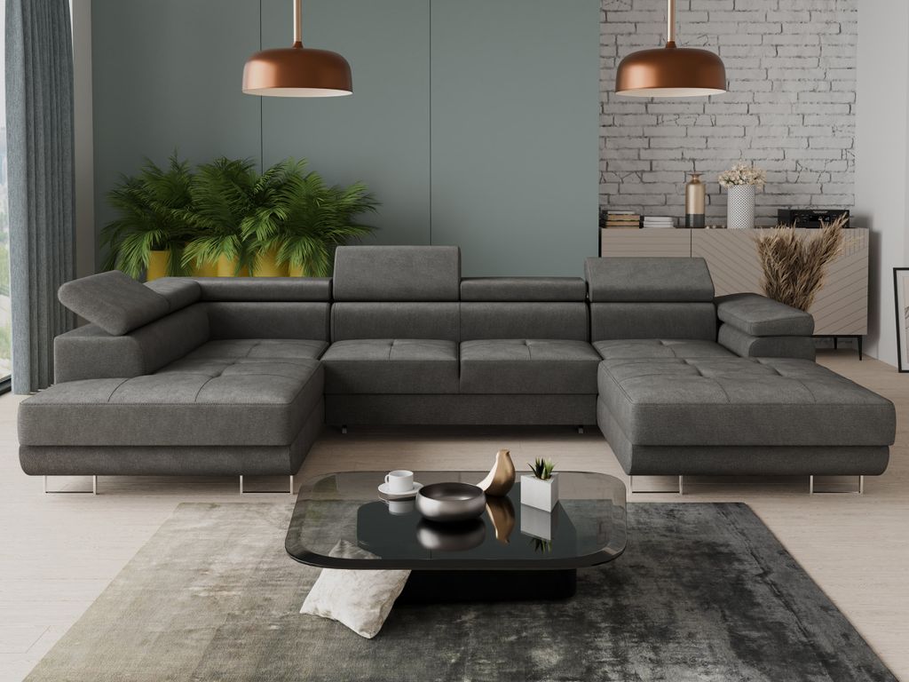 A modern living room with a large sectional sofa, coffee table, plants, and a credenza.