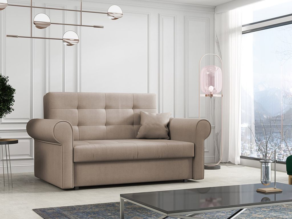 A beige sofa is shown in a well-lit room with a large window overlooking a snowy landscape.