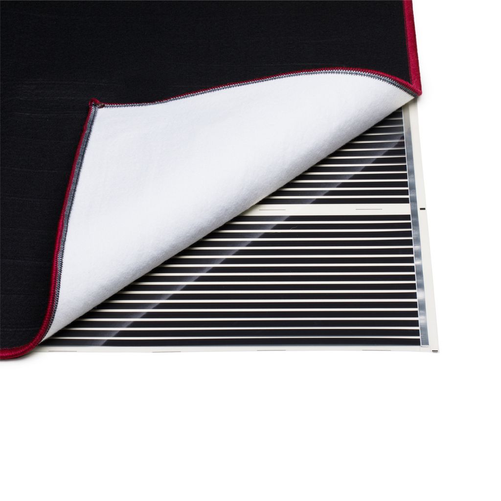 A close-up view of a heating mat with a black fabric cover partially lifted to reveal the heating elements.