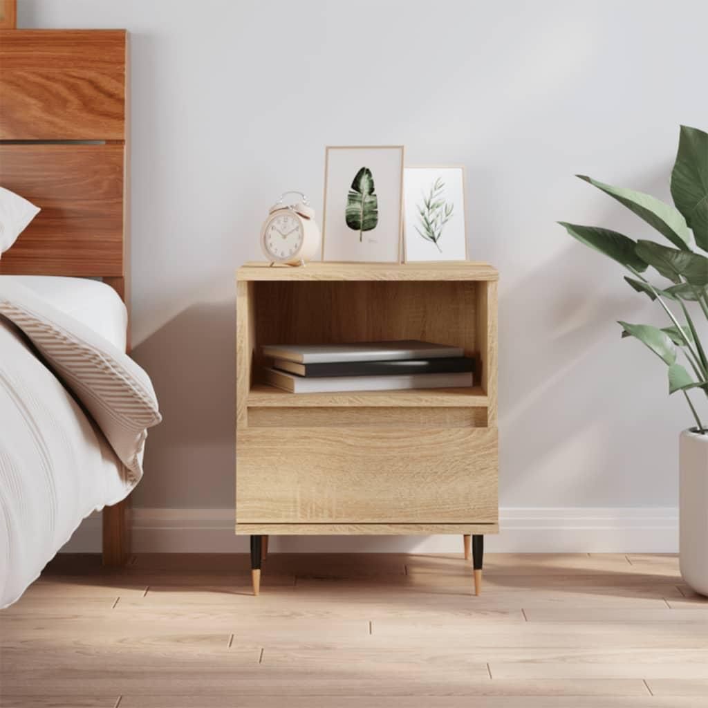 A bedside table next to a bed in a bedroom.