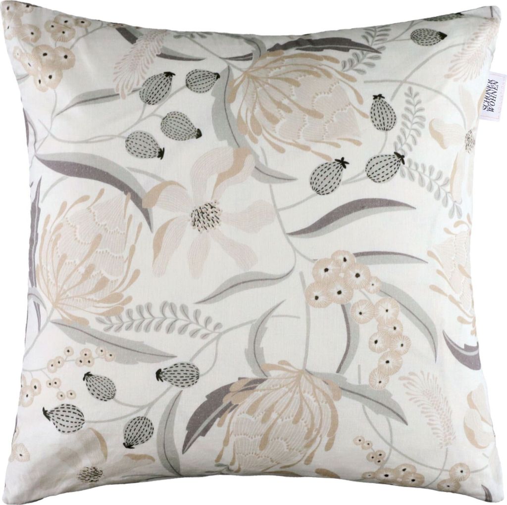 A close-up studio shot of a decorative pillow cover with a floral pattern.