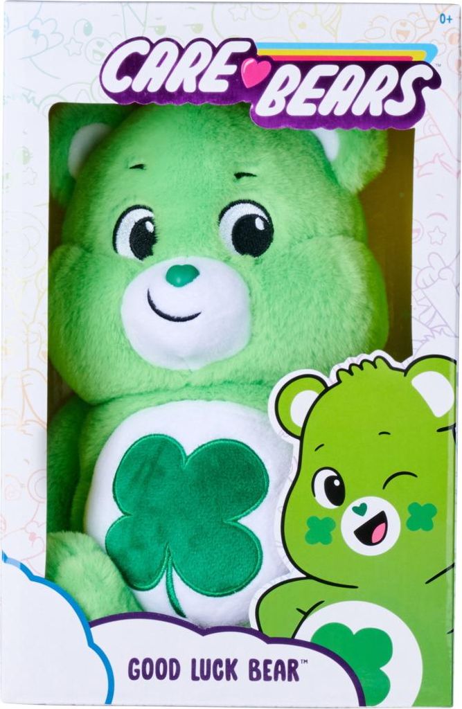 A green Care Bear plush toy named Good Luck Bear is shown in its packaging.