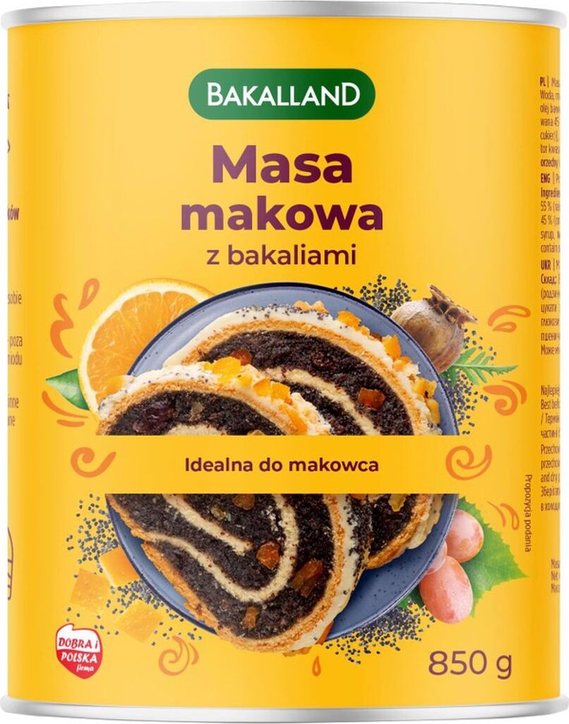 A can of Bakalland Masa makowa (poppy seed filling with dried fruits) with a slice of poppy seed roll on a plate, surrounded by decorative elements like orange slices and poppy seeds.