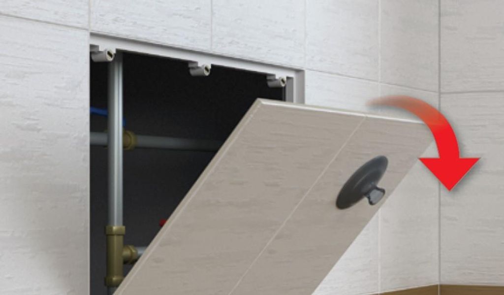 A tiled wall with an open access panel revealing plumbing pipes. A tiled panel is shown opening outwards.