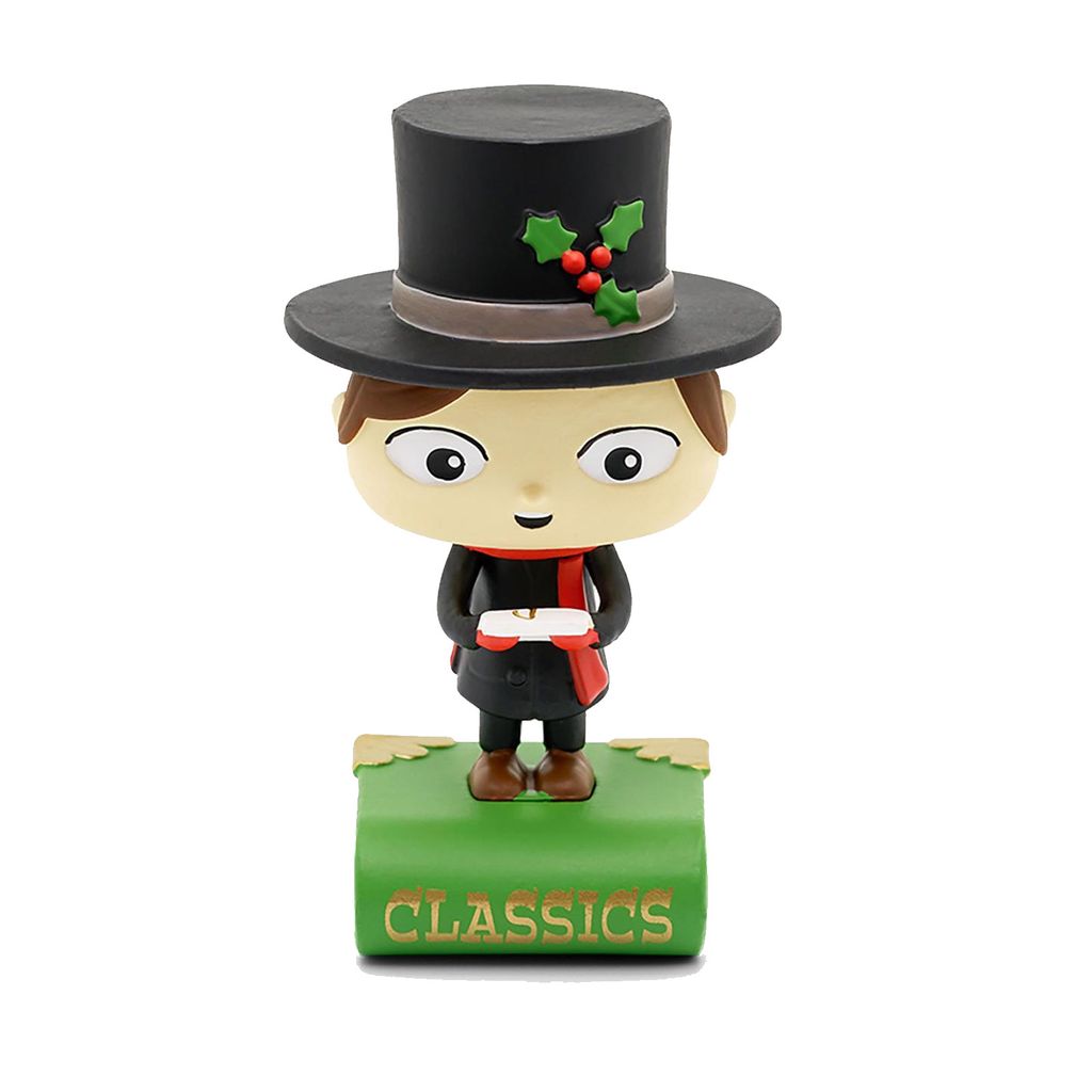 A figurine of a boy in a top hat holding a candle, standing on a green book with the word 'CLASSICS' on it.