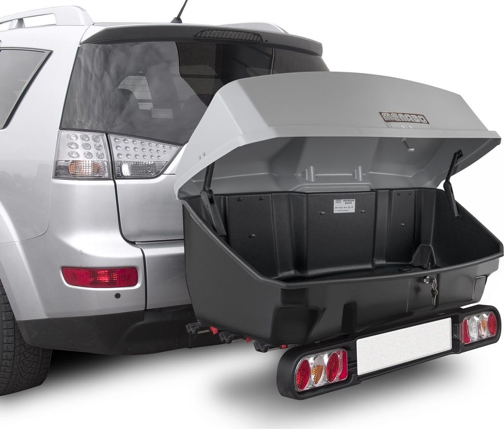 Rear view of a silver SUV with an open cargo carrier attached to the hitch.