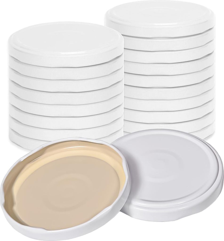 Stacks of white screw-on lids for jars, with one lid shown open to reveal its tan interior.