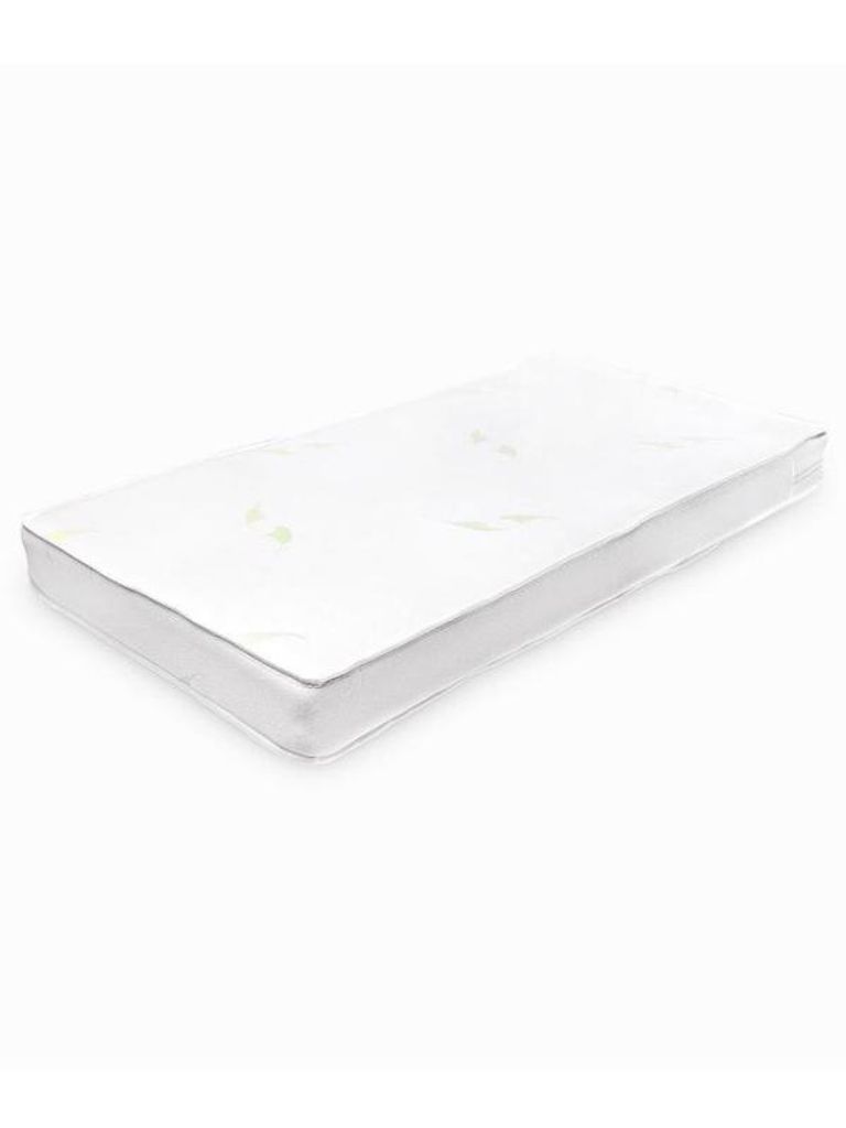 A white baby mattress is shown from a slightly elevated side angle against a white background.
