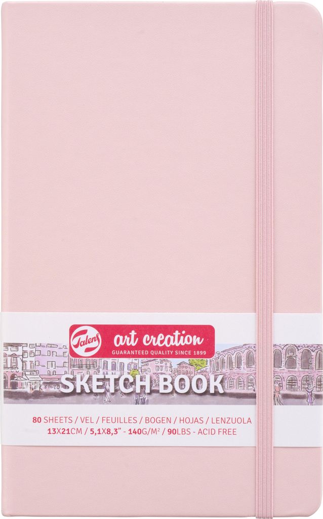 A pink sketchbook with an elastic band closure and a label band around it.
