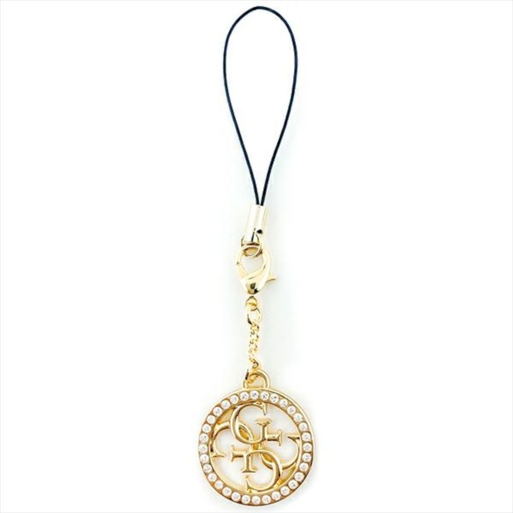 A gold-colored charm with the Guess logo and clear stones, attached to a black string, against a white background.