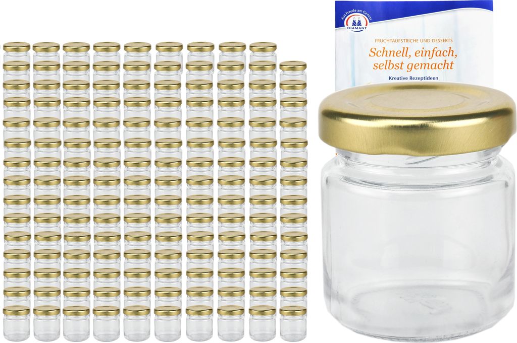 A stack of small glass jars with gold lids and a single jar with a gold lid and a small booklet.