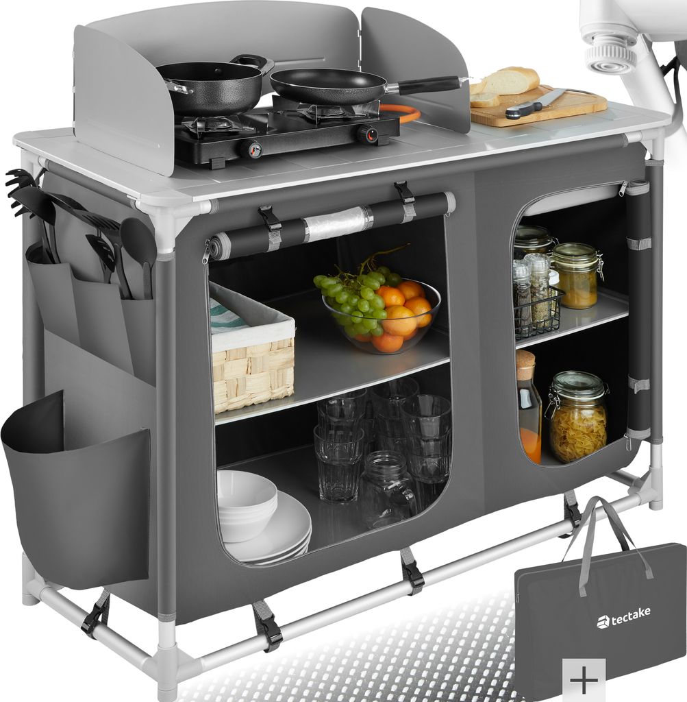 A camping kitchen setup with cooking utensils, food, and storage compartments.