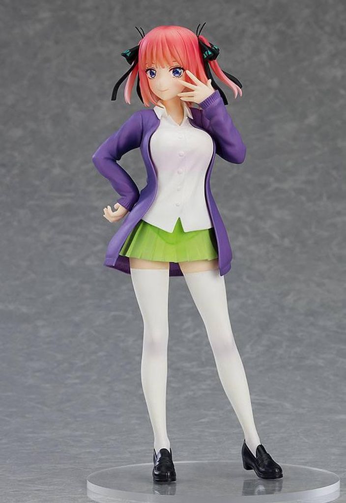A figurine of an anime character standing against a plain background.