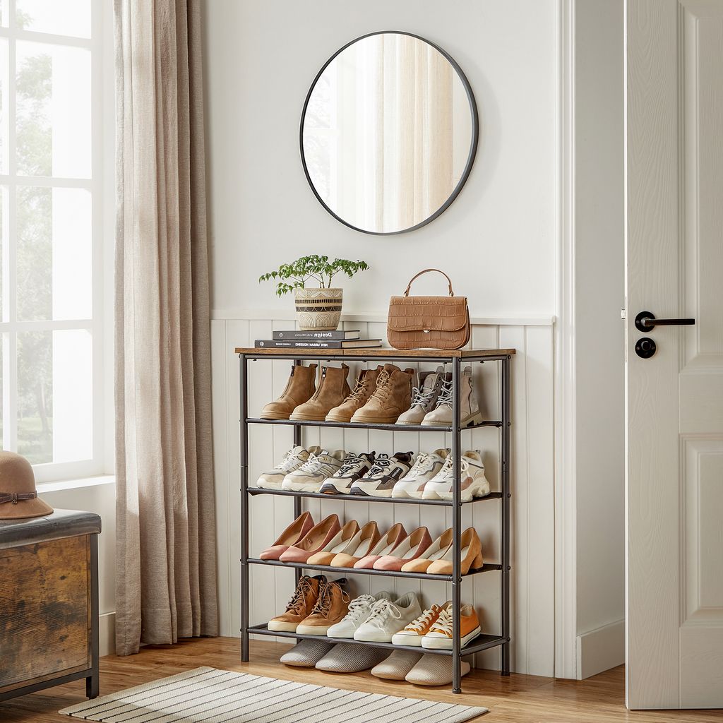 An entryway with a shoe rack filled with shoes, a mirror on the wall, and a handbag on top of the shoe rack.