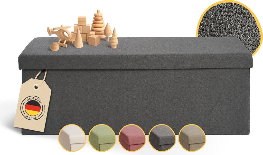 A dark gray storage bench with wooden toys on top and color swatches below.