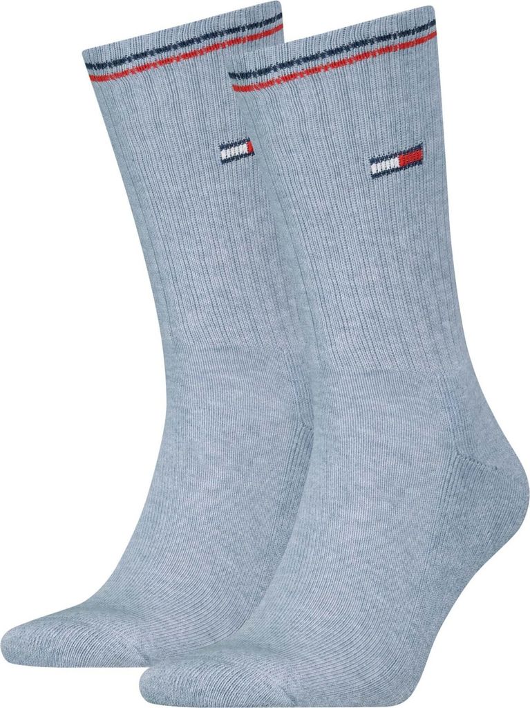 A pair of light blue socks with red and navy stripes at the top and a small Tommy Hilfiger logo on each sock.