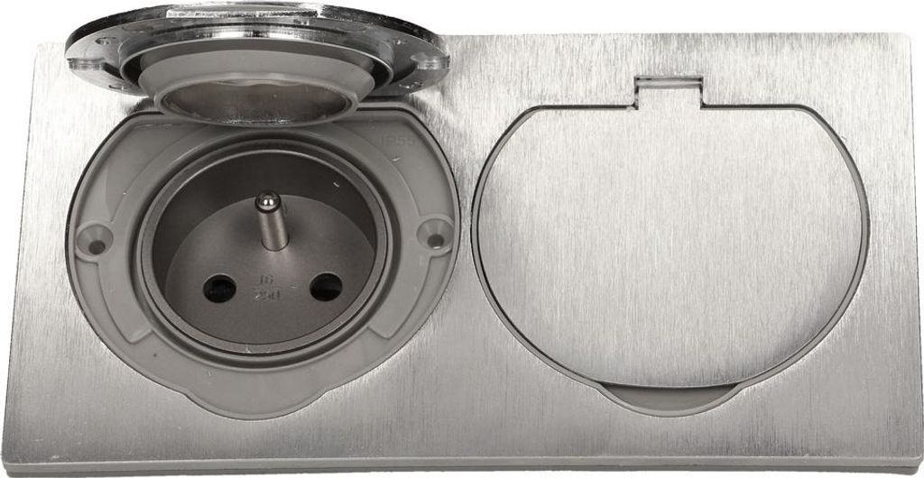 A close-up, top-down view of a recessed electrical outlet with a hinged cover.