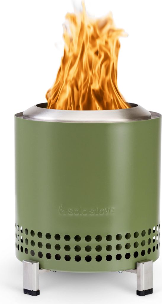 A green Solo Stove Mesa XL fire pit with flames burning inside, set against a white background.