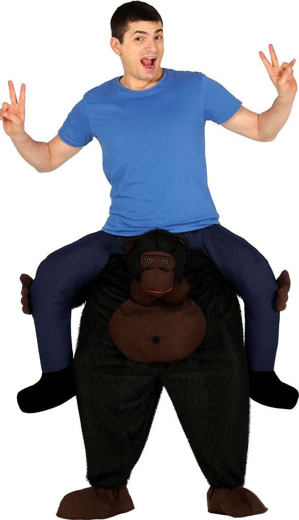 A man wearing a blue t-shirt and dark blue pants is posing on a gorilla costume.