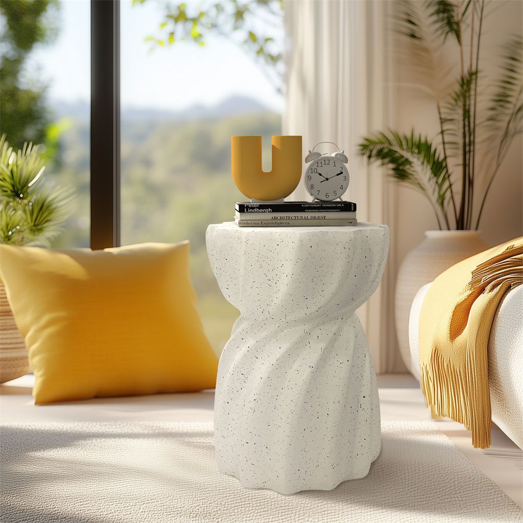 A bright and airy living room setting with a small white speckled side table as the focal point.