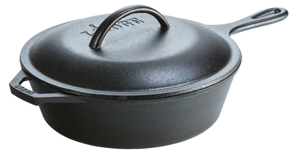 A black cast iron skillet with a lid is shown from a side angle against a white background.