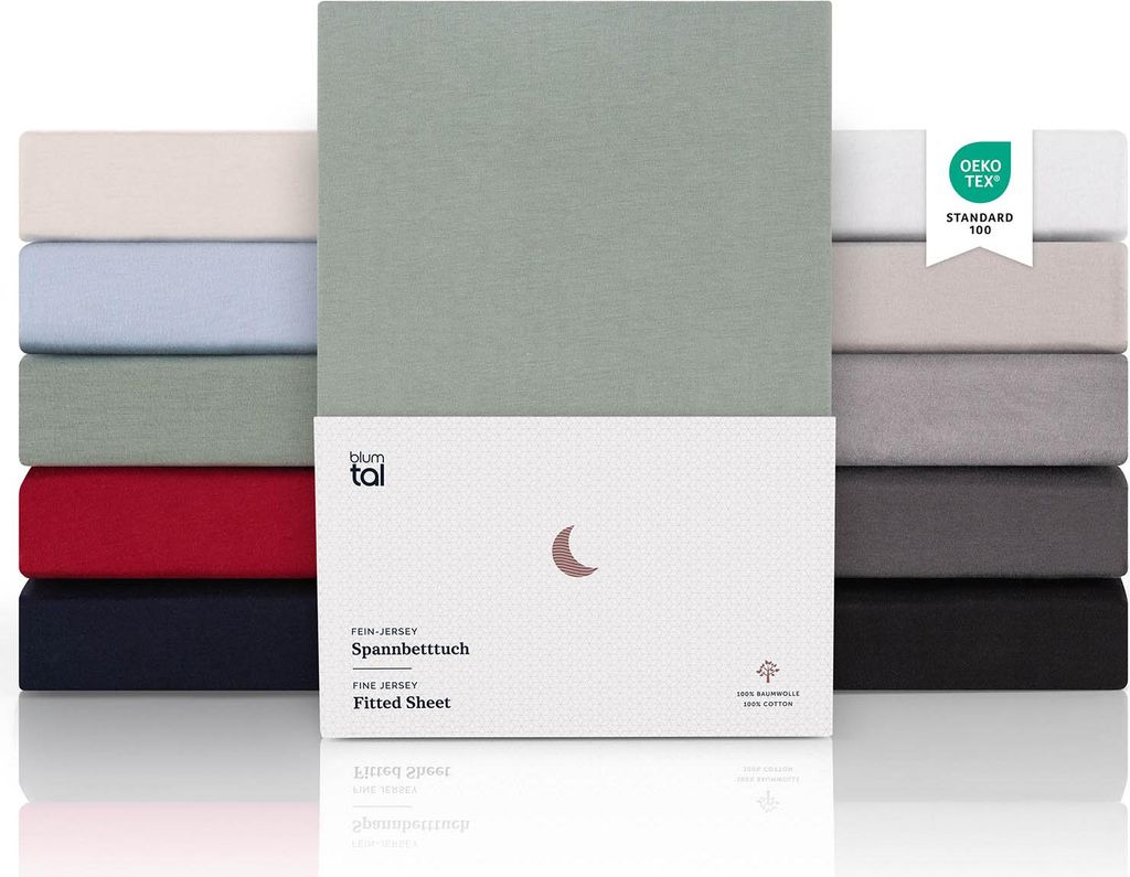 A stack of folded fitted sheets in various colors, with a product box in the foreground.