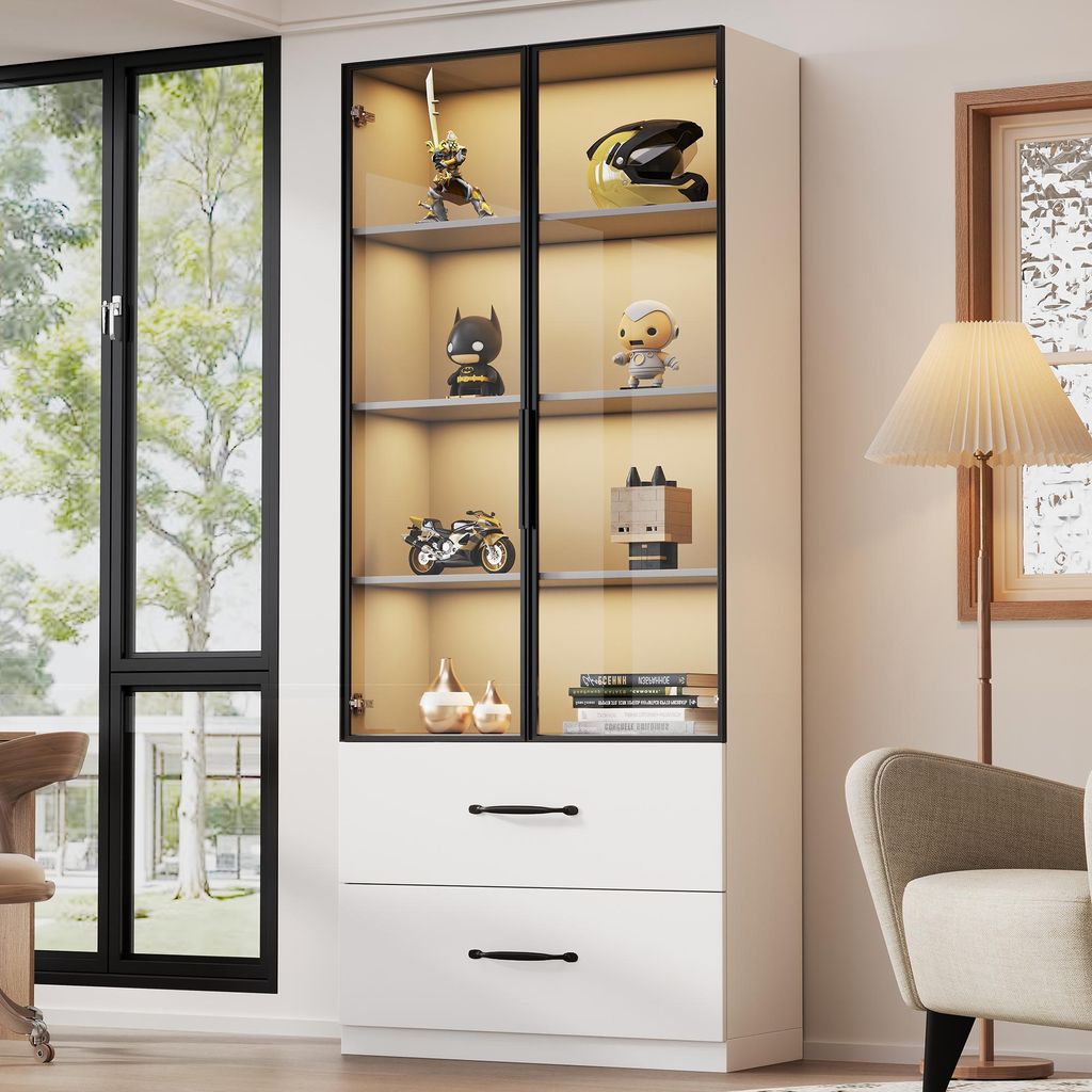 A display cabinet with various items on shelves, next to a window and a lamp.