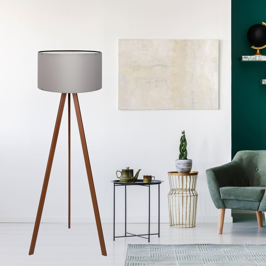 A modern living room with a floor lamp, armchair, and side table.