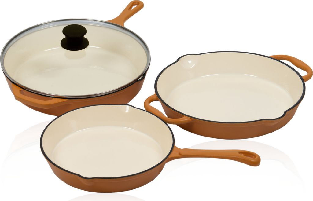 Three cast iron frying pans of different sizes are arranged on a white background.