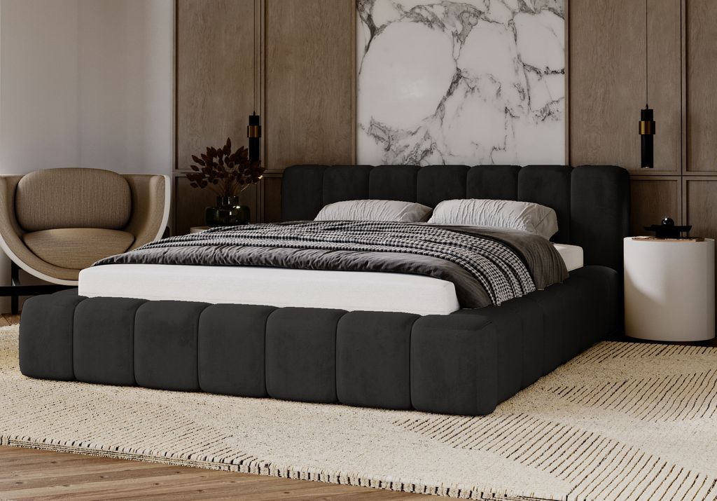 A modern bedroom scene featuring a dark upholstered bed with a patterned rug and a decorative chair.