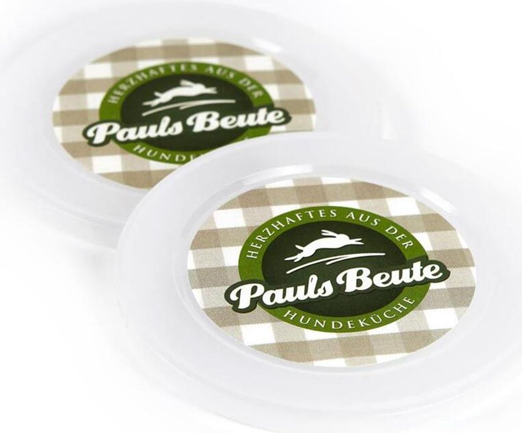 Two white plastic lids with a circular label featuring a checkered pattern and branding.