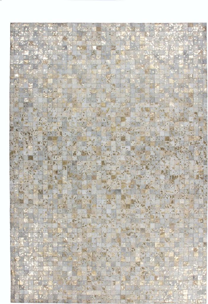 A close-up, overhead view of a rug with a mosaic-like pattern of small squares in ivory and gold.