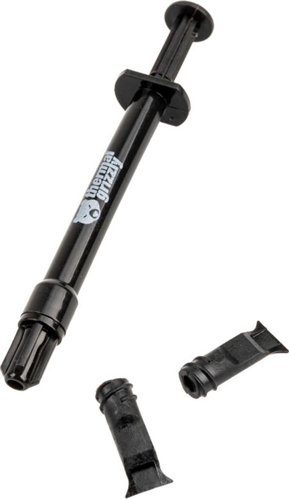 A black syringe of thermal paste with two detached caps.