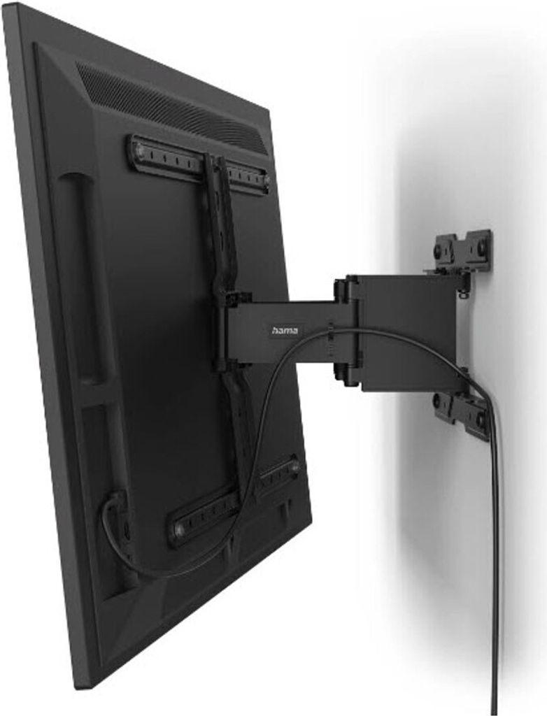 A black TV wall mount is attached to a black flat-screen television, which is mounted on a white wall.