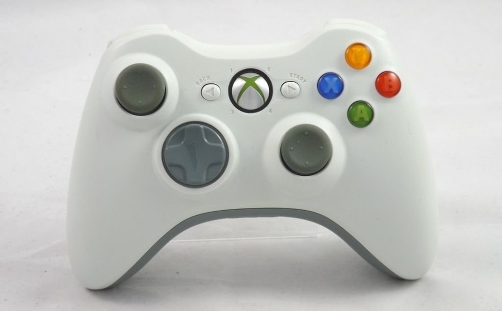 A white Xbox 360 wireless controller is shown against a white background.